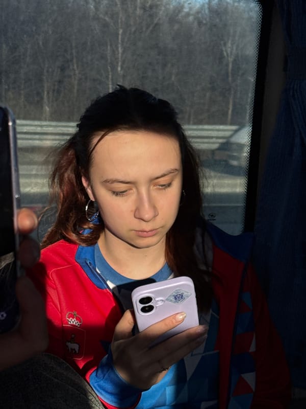 Woman uses phone while seated in vehicle in Yanychi