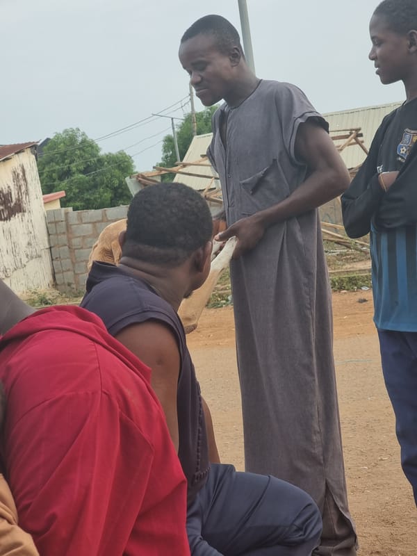 Everyday moments captured in Gwagwalada: men gathering, child feeding
