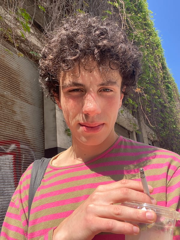Person smoking cigarette outdoors in Tel Aviv morning
