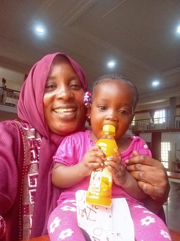 Mother and child share quiet moment in Akwanga hall