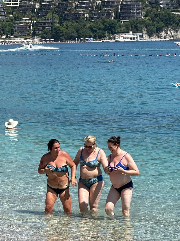 Summer beach day brings swimmers, parasailers to Budva coast