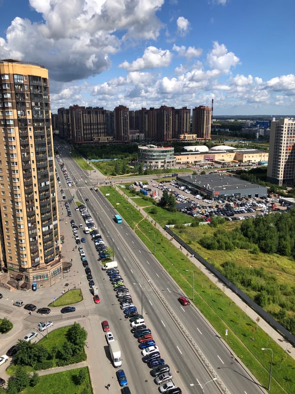 Aerial sweep of a busy urban residential district on a clear morning