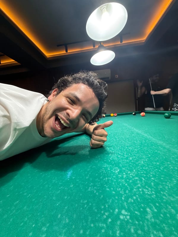 Man takes thumbs-up selfie at pool table in Tashkent