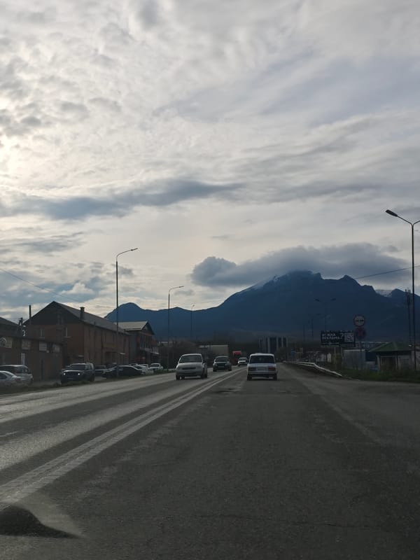 Street scene captured in Inozemtsevo with mountains backdrop