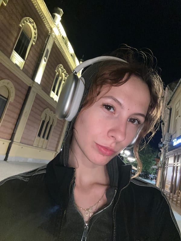 Woman takes nighttime selfies at Serbian National Theatre, Novi Sad