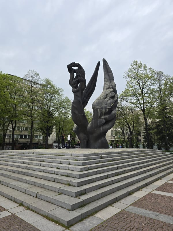 Cats and flora observed around dark winged monument