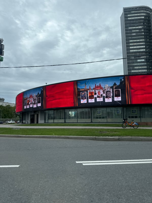 Digital billboard shows portraits against Kremlin backdrop in Moscow