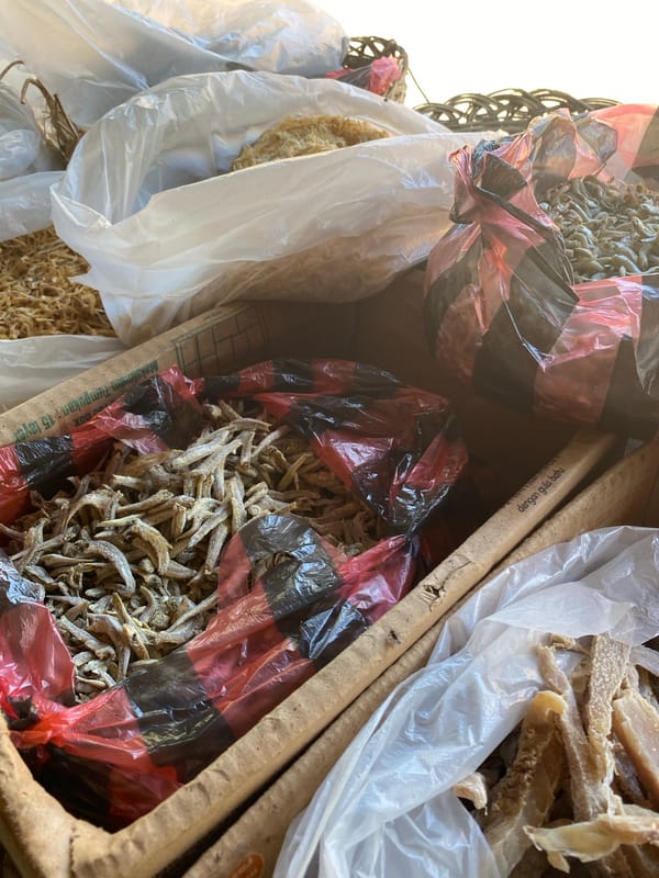 Local market stall stocked with dried goods and fresh produce
