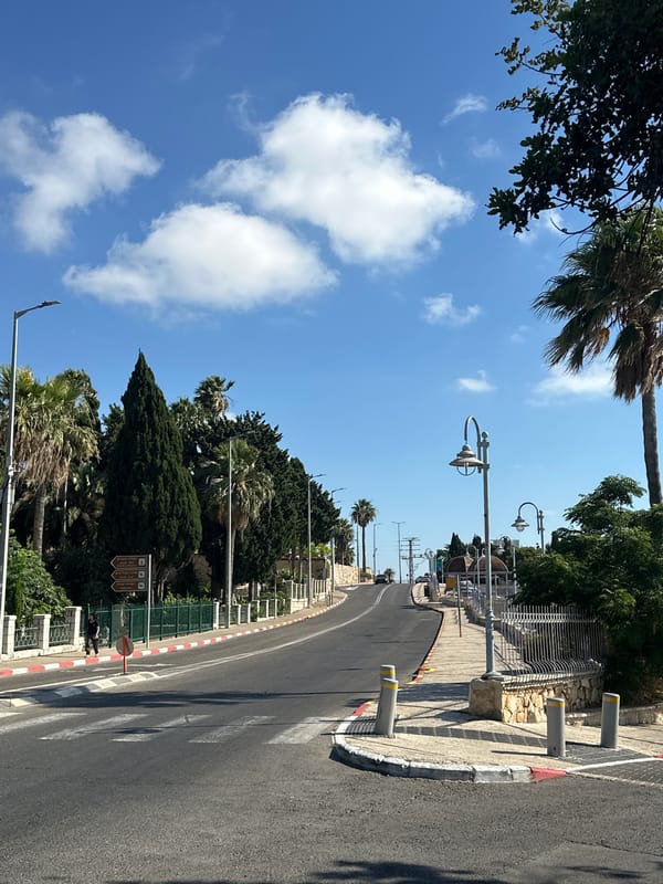 Street-level scenes from a Haifa neighborhood on a sunny afternoon