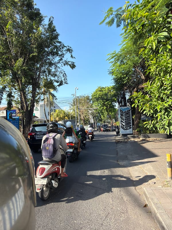 North Kuta street traffic under wires and open sky