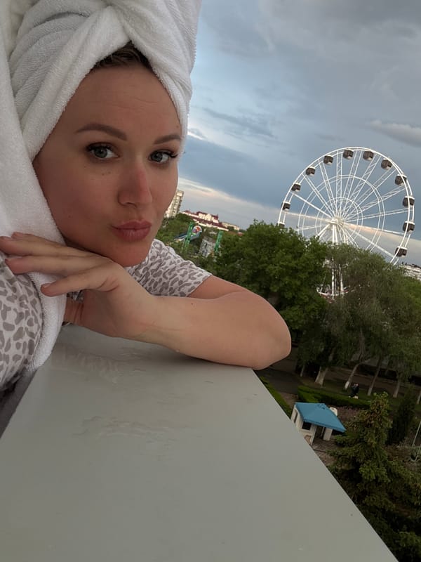 Woman photographed with towel near Ferris wheel in Yevpatoriya