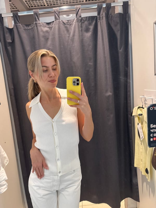 Woman takes dressing room selfies while trying on clothes