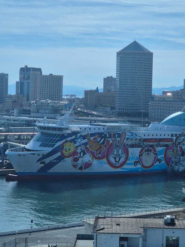 Cruise ship, tugboats spotted at Genoa Harbor during sunny afternoon