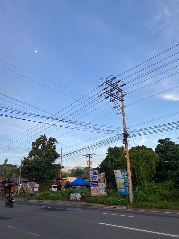 Davao City roadside at golden hour, wires and all