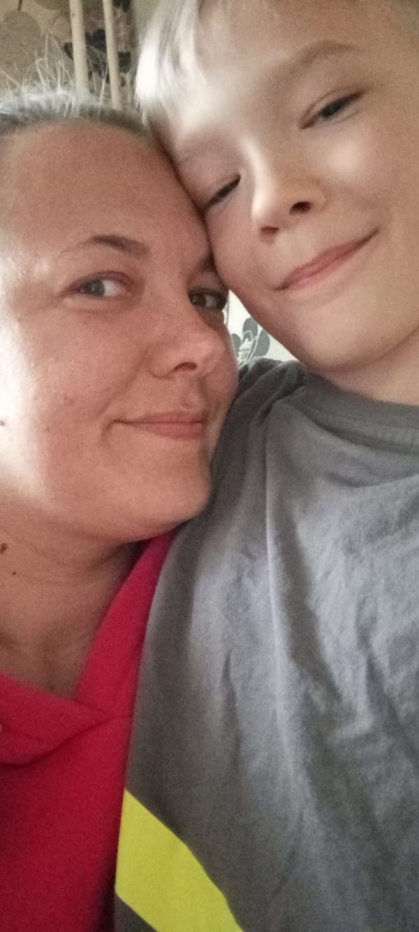 Mother and son share moment with toy duck in Dmitrov