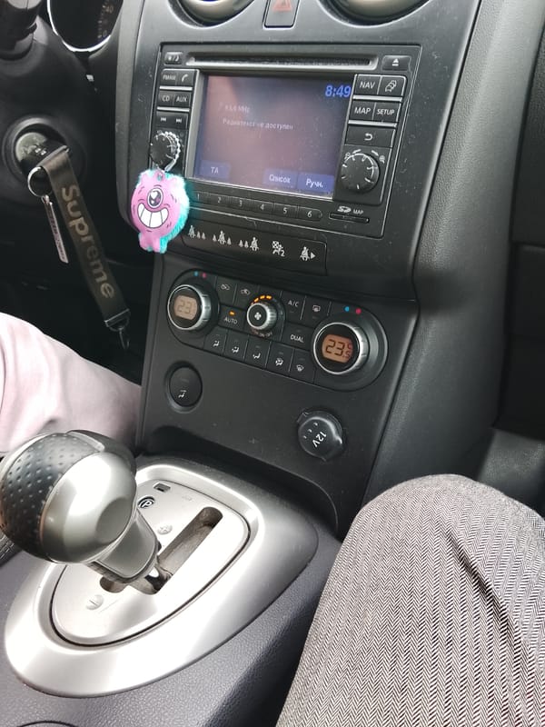 Car interior documented in Russian town shows dashboard, clothing