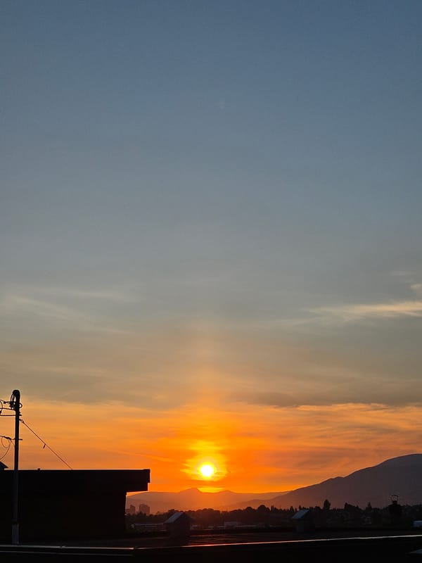 Vancouver sunset glows orange from a rooftop vantage point