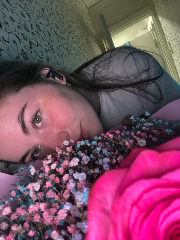 Woman documents quiet evening with flowers and cat in Chaikovsky