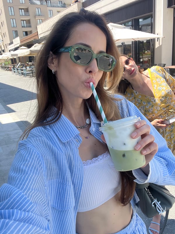 Woman enjoys morning coffee and sightseeing in Tivat, Montenegro