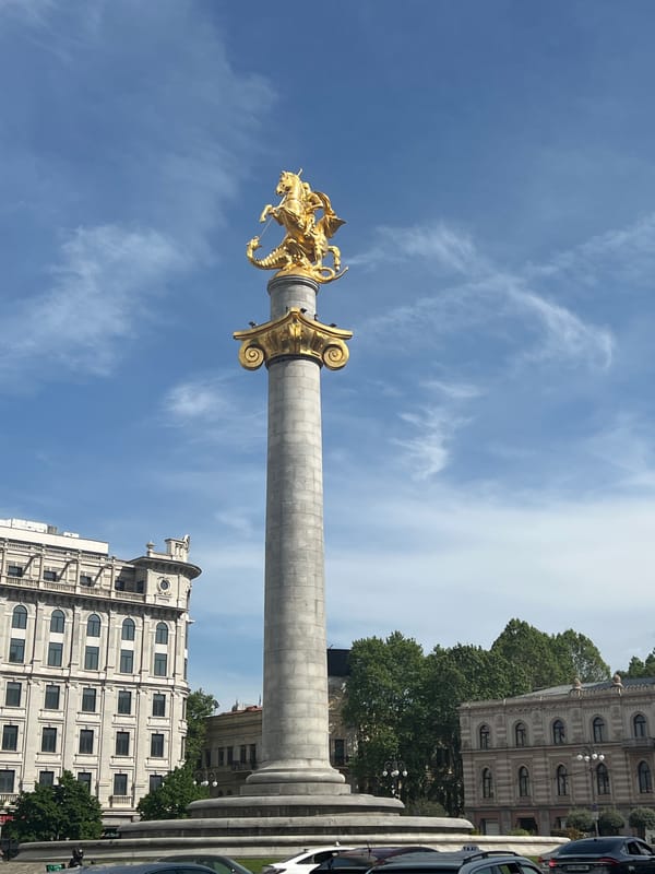 Tourist captures Tbilisi landmarks and Georgian cultural souvenir