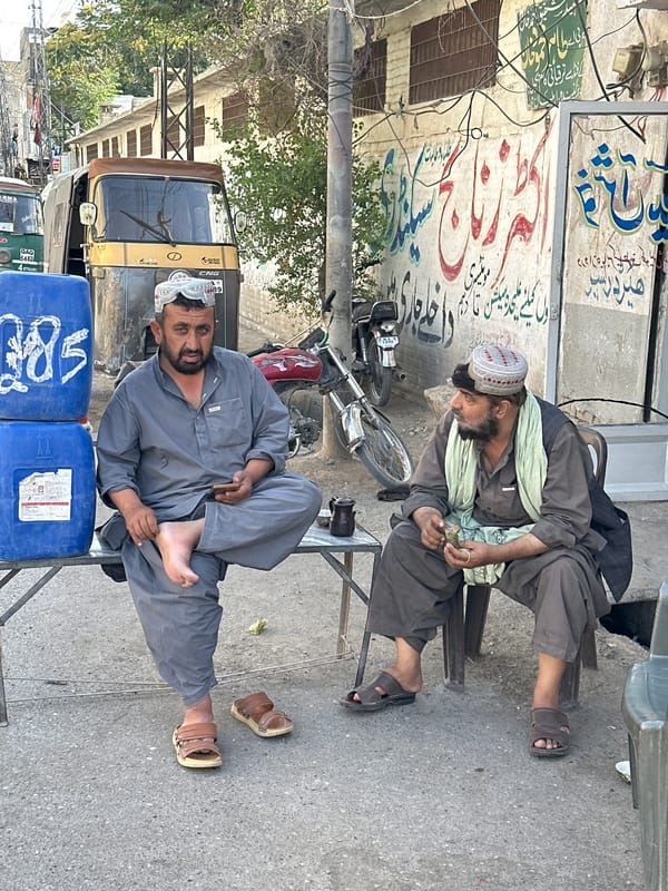 Everyday street life across a busy Quetta neighborhood