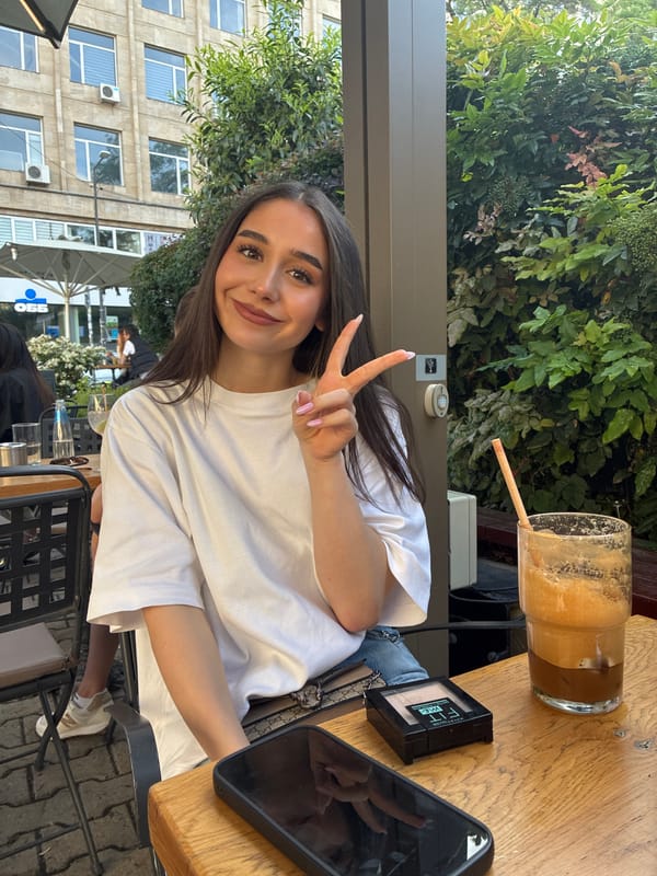 Sofia cafe scene: woman poses, guitarist performs outdoors