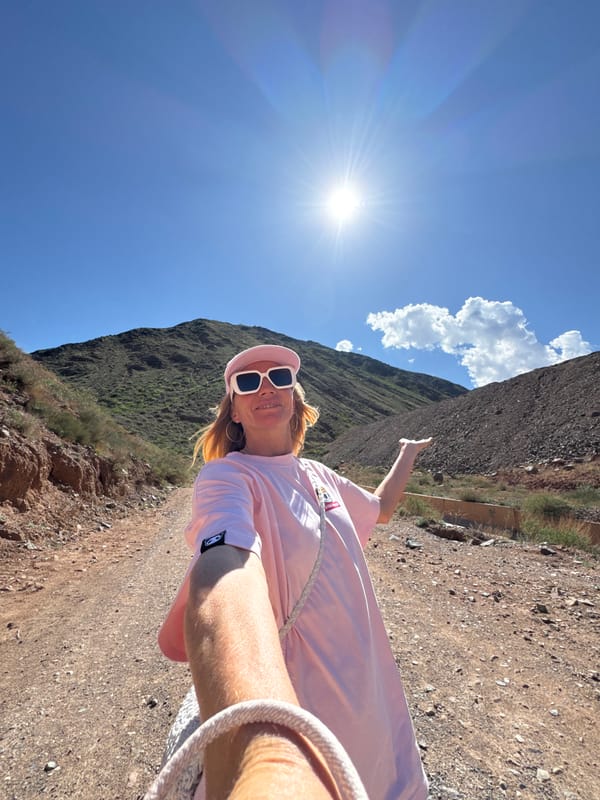 Woman hikes mountain trail near Krasnyy Most, Kyrgyzstan