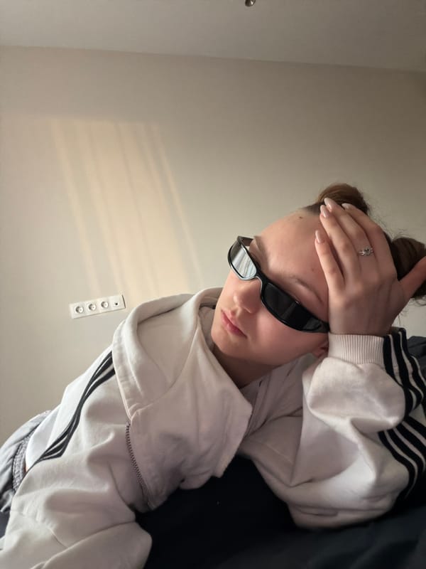 Person in "shadowbanned" shirt rests indoors in Moscow