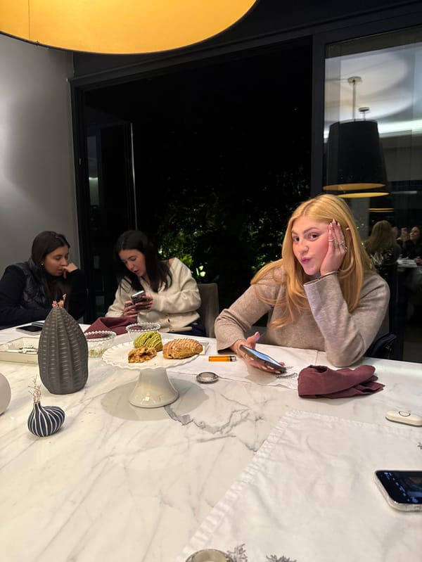 Two women share early morning phone time at Mexico City cafe