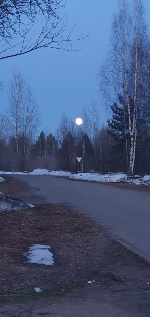 Rural road scene captured in Chernushka with snow patches