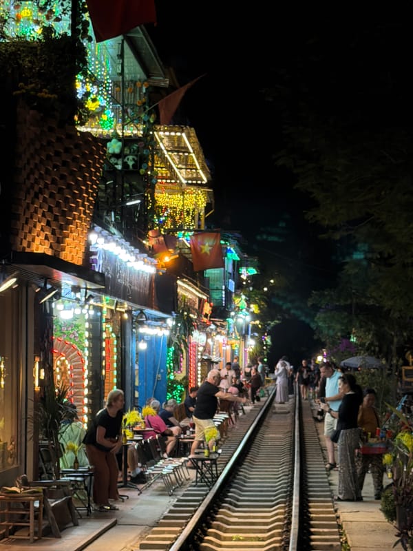 Crowds gather at night on Hanoi's Train Street railway