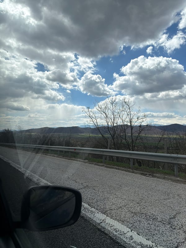 Vehicle travels highway near Ihtiman, Bulgaria capturing roadside scenery