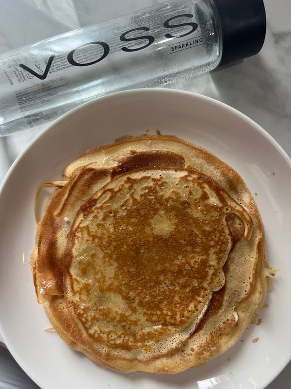 Pancakes and VOSS water styled on a marble countertop in Choeng Thale
