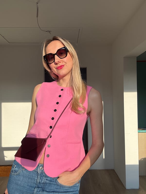 Woman in pink vest photographed indoors in Carnikava