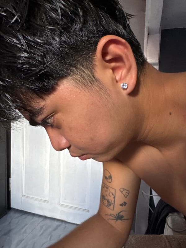 Tattooed person and dachshund captured in intimate home moments