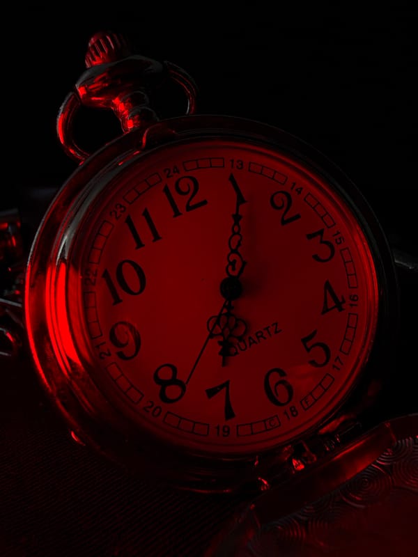 Gothic accessory shoot: pocket watches, spikes, and red lighting