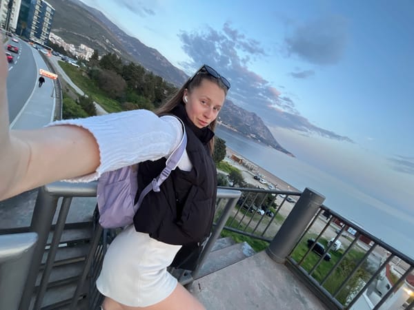 Tourist takes selfie while walking through Montenegrin coastal town