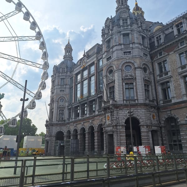 Ferris wheel and grand station define central Antwerp streetscape