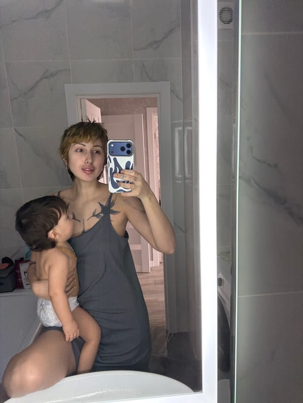 Woman Takes Bathroom Mirror Selfies with Infant in Bataysk