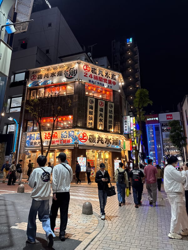 Evening street life documented in Shinjuku commercial district