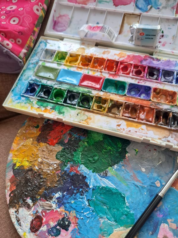 Artist's palette and supplies at a window in Popovo