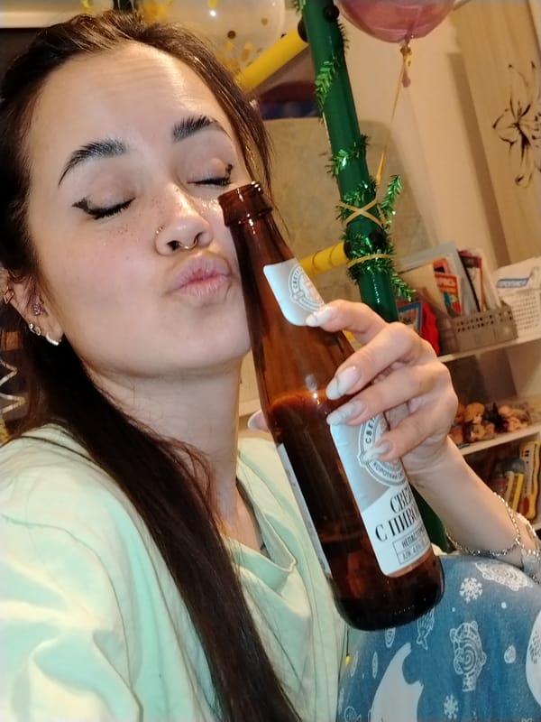 Tattooed woman lies amid gold confetti in Noviy, Russia