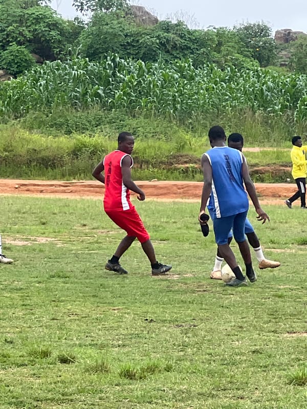 Pickup soccer practice on a patchy field in Jos, Nigeria