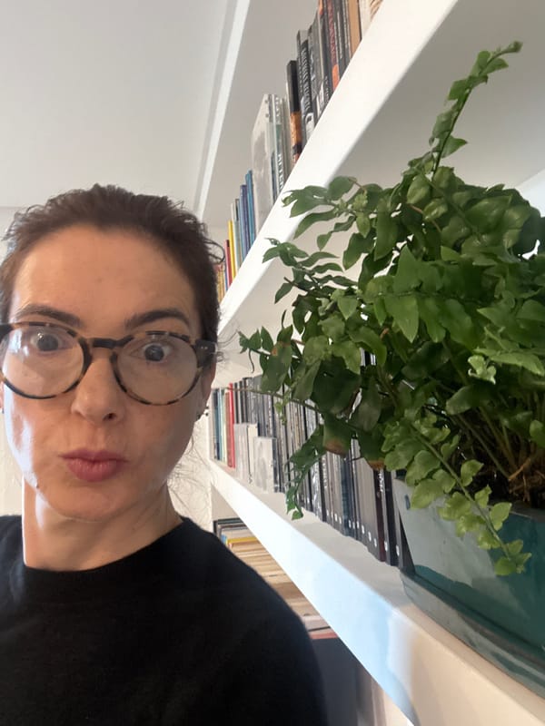 Woman photographed near bookshelf in Vila Nova de Gaia