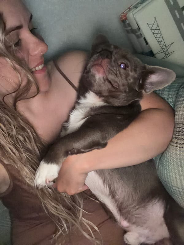 Woman and French Bulldog share quiet moment in Votkinsk