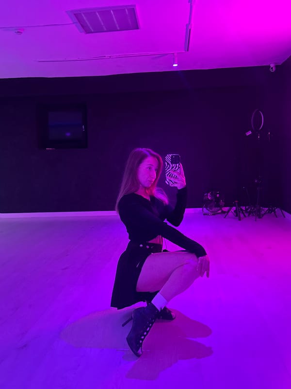 Woman poses for purple-lit selfie session in Chaikovsky
