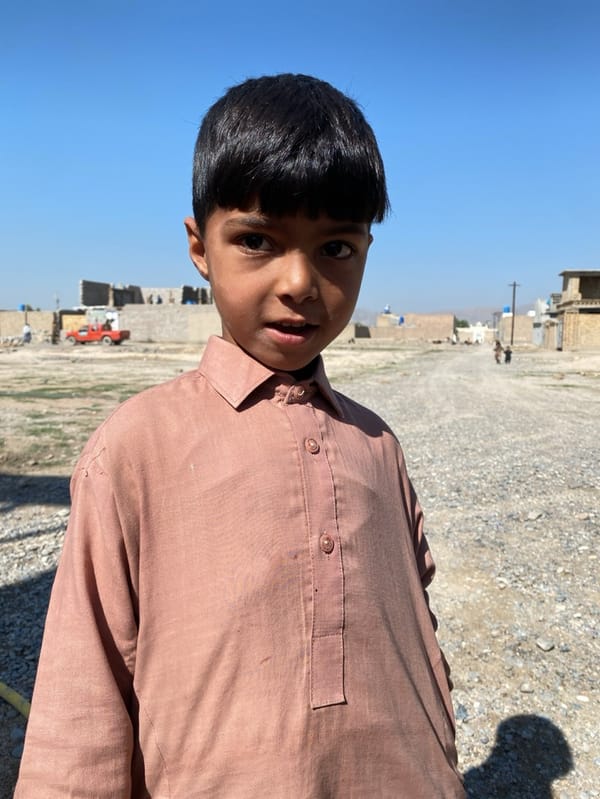 Young boys gather in developing Kandahar neighborhood