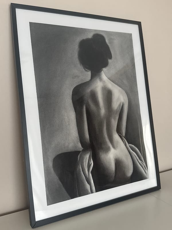 Charcoal nude drawing observed on wall display