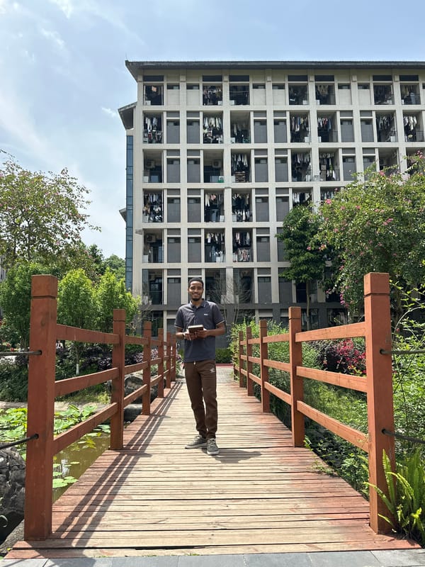 Man with book observed on wooden bridge in Jiangjin