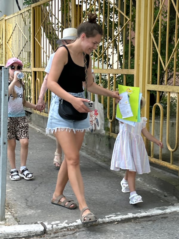 Casual outdoor moment near a yellow fence in Gelendzhik